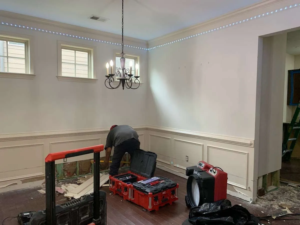 Restoration technician with professional equipment in East Hills